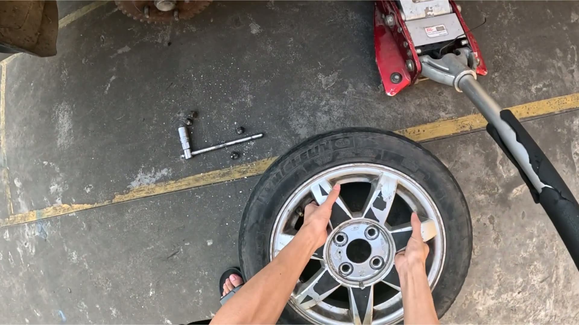 Still from a Tire Fitting recording showing a tire being mounted onto a vehicle wheel